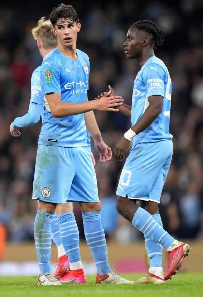 Finley Burns of Manchester City interacts with team mate Romeo Lavia during the Carabao Cup Third Round match between Manchester City and Wycombe...