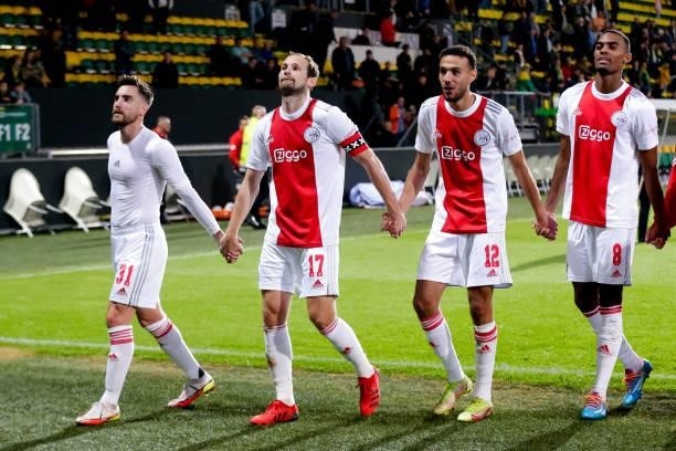 Nico Tagliafico of Ajax, Daley Blind of Ajax, Noussair Mazraoui of Ajax and Ryan Gravenberch of Ajax celebrate theirs sides win during the Dutch...