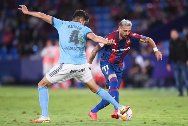 Jose Luis Morales of Levante is challenged by Nestor Araujo of Celta Vigo during the La Liga Santander match between Levante UD and RC Celta de Vigo...