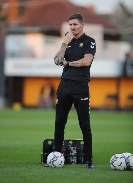 Cambridge United coach Barry Corr looks on during the pre match warm up prior to the Papa John's Trophy match between Cambridge United and Tottenham...