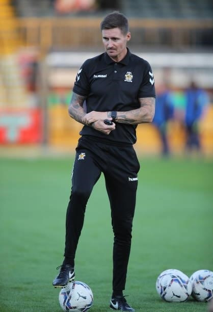 Cambridge United coach Barry Corr looks on during the pre match warm up prior to the Papa John's Trophy match between Cambridge United and Tottenham...
