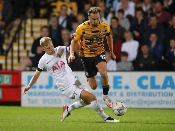 Sam Smith of Cambridge United moves past the challenge of Harvey White of Tottenham Hotspur U21 during the Papa John's Trophy match between Cambridge...