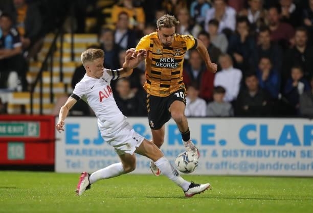 Sam Smith of Cambridge United moves past the challenge of Harvey White of Tottenham Hotspur U21 during the Papa John's Trophy match between Cambridge...