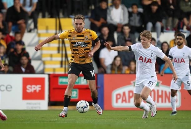 Sam Smith of Cambridge United moves with the ball away from Matthew Craig of Tottenham Hotspur U21 during the Papa John's Trophy match between...
