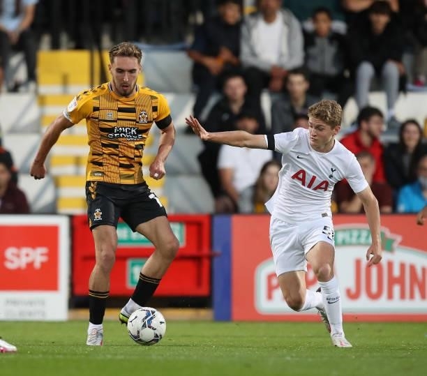 Sam Smith of Cambridge United moves with the ball away from Matthew Craig of Tottenham Hotspur U21 during the Papa John's Trophy match between...