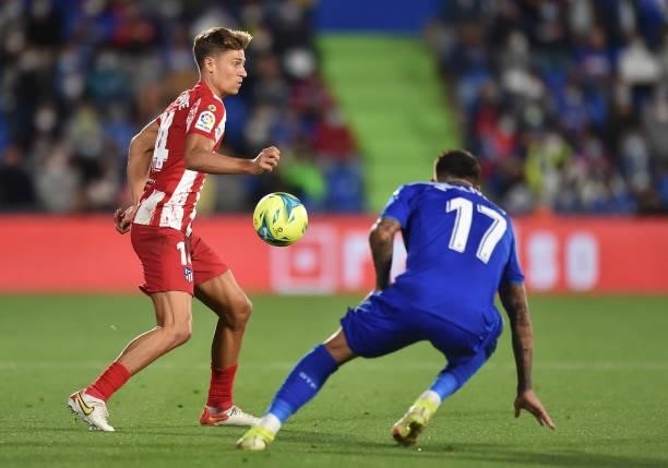 Marcos Llorente of Atletico de Madrid controls the ball while being challenged by Mathias Olivera of Getafe CF during the La Liga Santander match...