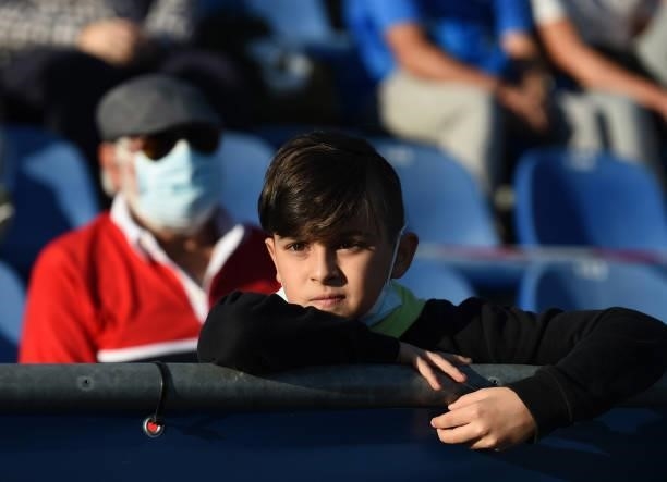 Young boy looks on prior to the start of the La Liga Santander match between Getafe CF and Club Atletico de Madrid at Coliseum Alfonso Perez on...