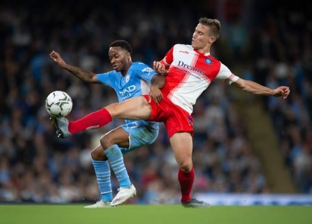 Raheem Sterling of Manchester City and David Wheeler of Wycombe Wanderers in action during the Carabao Cup Third Round match between Manchester City...