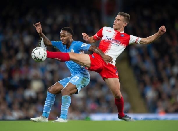 Raheem Sterling of Manchester City and David Wheeler of Wycombe Wanderers in action during the Carabao Cup Third Round match between Manchester City...