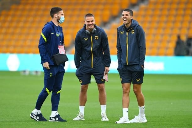 Matt Doherty of Tottenham Hotspur speaks to Leander Dendoncker and Conor Coady of Wolverhampton Wanderers prior to the Carabao Cup Third Round match...
