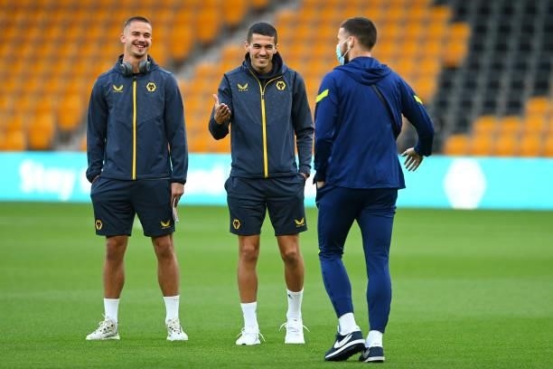 Leander Dendoncker and Conor Coady of Wolverhampton Wanderers interact with Matt Doherty of Tottenham Hotspur prior to the Carabao Cup Third Round...