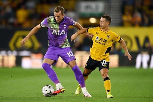 Harry Kane of Tottenham Hotspur is closed down by Daniel Podence of Wolverhampton Wanderers during the Carabao Cup Third Round match between...