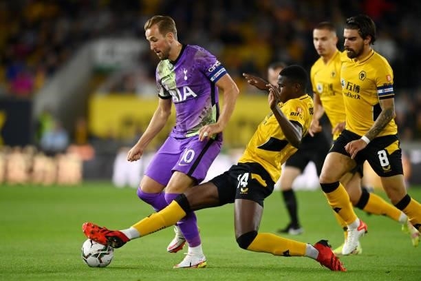 Harry Kane of Tottenham Hotspur is challenged by Yerson Mosquera of Wolverhampton Wanderers during the Carabao Cup Third Round match between...