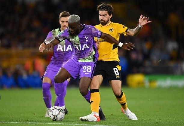 Tanguy Ndombele of Tottenham Hotspur is challenged by Ruben Neves of Wolverhampton Wanderers during the Carabao Cup Third Round match between...