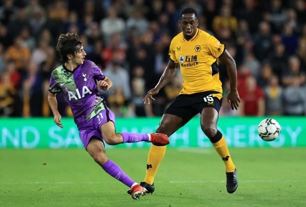 Bryan Gil of Tottenham Hotspur battles for possession with Willy Boly of Wolverhampton Wanderers during the Carabao Cup Third Round match between...