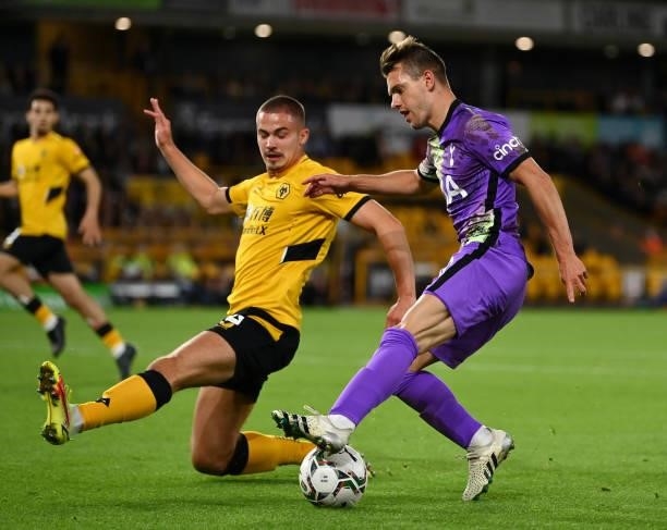 Giovani Lo Celso of Tottenham Hotspur is closed down by Leander Dendoncker of Wolverhampton Wanderers during the Carabao Cup Third Round match...