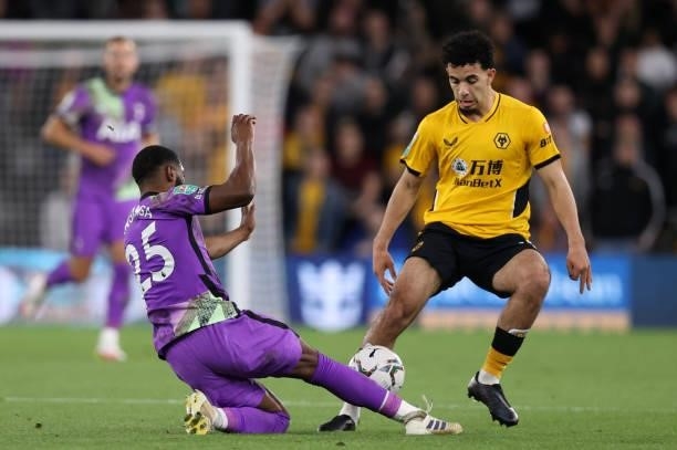 Japhet Tanganga of Tottenham Hotspur tackles Rayan Ait-Nouri of Wolverhampton Wanderers during the Carabao Cup Third Round match between...