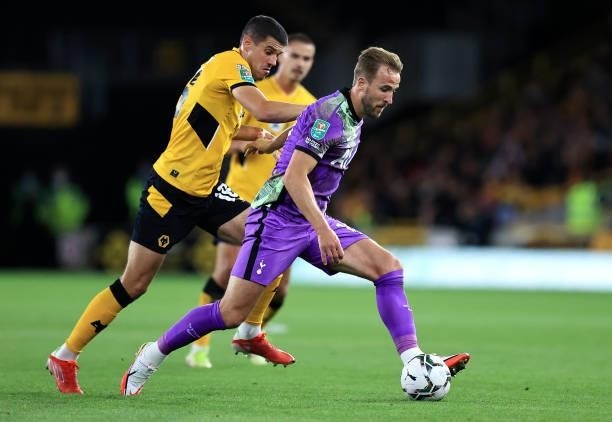 Harry Kane of Tottenham Hotspur is challenged by Conor Coady of Wolverhampton Wanderers during the Carabao Cup Third Round match between...