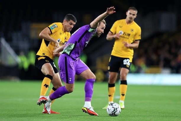 Harry Kane of Tottenham Hotspur is challenged by Conor Coady of Wolverhampton Wanderers during the Carabao Cup Third Round match between...