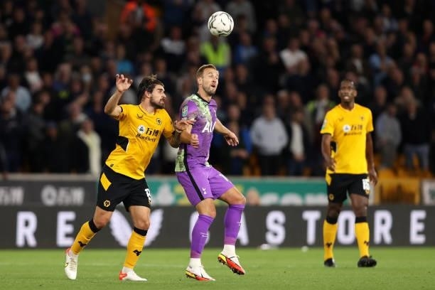 Harry Kane of Tottenham Hotspur battles for possession with Ruben Neves of Wolverhampton Wanderers during the Carabao Cup Third Round match between...
