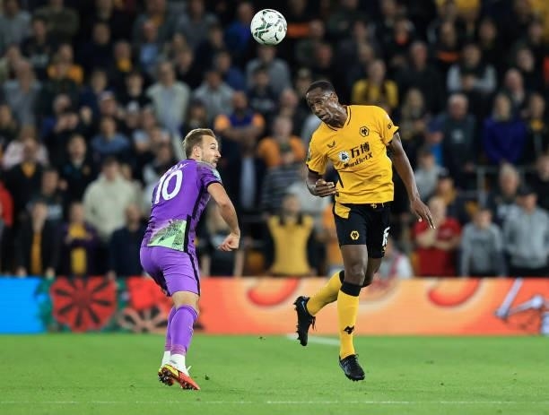 Willy Boly of Wolverhampton Wanderers heads away from Harry Kane of Tottenham Hotspur during the Carabao Cup Third Round match between Wolverhampton...