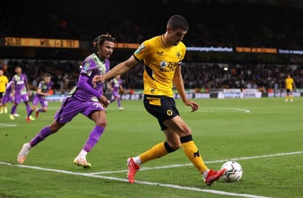 Conor Coady of Wolverhampton Wanderers passes the ball whilst under pressure from Dele Alli of Tottenham Hotspur during the Carabao Cup Third Round...