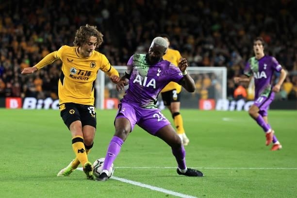 Fabio Silva of Wolverhampton Wanderers is tackled by Tanguy Ndombele of Tottenham Hotspur during the Carabao Cup Third Round match between...