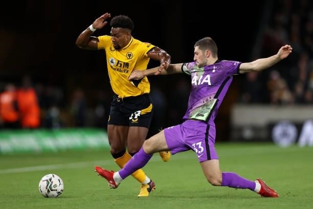 Adama Traore of Wolverhampton Wanderers is challenged by Ben Davies of Tottenham Hotspur during the Carabao Cup Third Round match between...