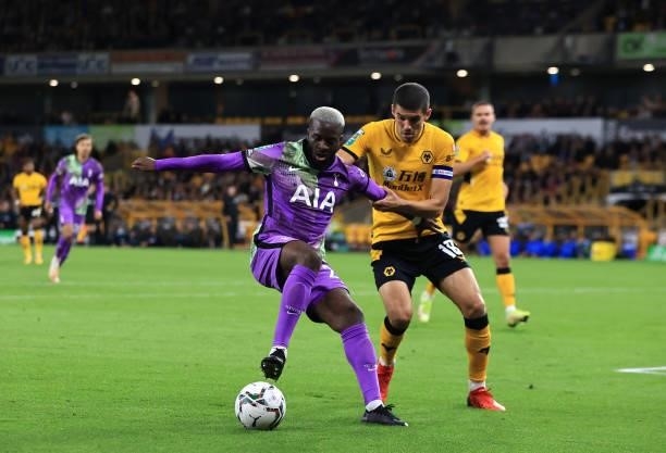Tanguy Ndombele of Tottenham Hotspur battles for possession with Conor Coady of Wolverhampton Wanderers during the Carabao Cup Third Round match...
