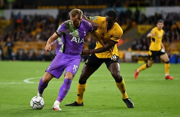 Harry Kane of Tottenham Hotspur battles for possession with Willy Boly of Wolverhampton Wanderers during the Carabao Cup Third Round match between...