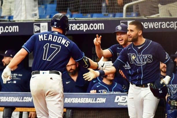 Kevin Kiermaier and Brett Phillips celebrate with Austin Meadows of the Tampa Bay Rays after a 3-run home run in the third inning against the Toronto...