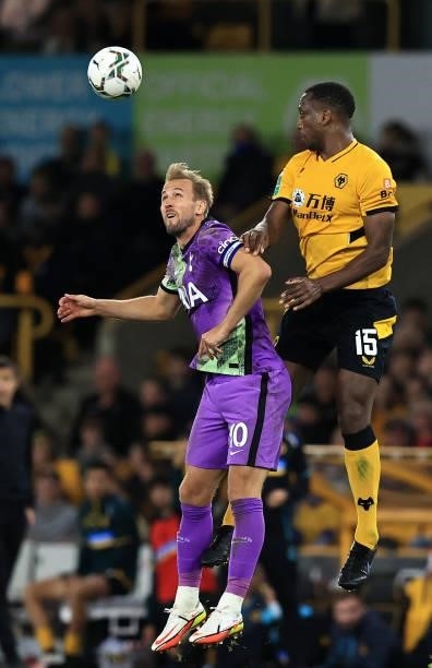 Harry Kane of Tottenham Hotspur jumps for the ball with Willy Boly of Wolverhampton Wanderers during the Carabao Cup Third Round match between...