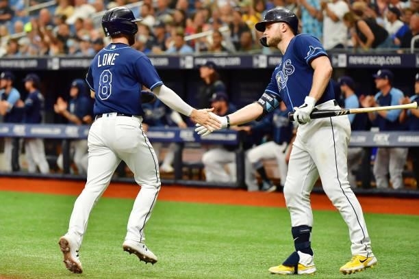 Austin Meadows celebrates with Brandon Lowe of the Tampa Bay Rays after a run in the third inning against the Toronto Blue Jays at Tropicana Field on...