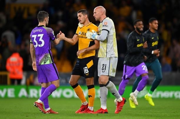 Conor Coady is embraced by Ben Davies of Tottenham Hotspur and John Ruddy of Wolverhampton Wanderers after his penalty miss in the Carabao Cup Third...