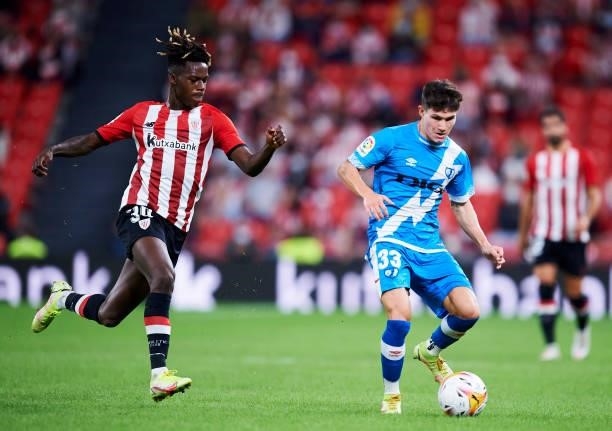 Nico Williams Jr of Athletic Club duels for the ball with Fran Garcia of Rayo Vallecano during the La Liga Santander match between Athletic Club and...