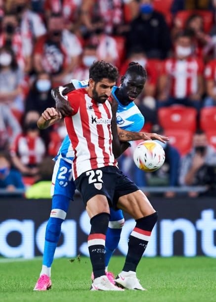 Raul Garcia of Athletic Bilbao battles for possession with Pathe Ciss of Rayo Vallecano during the La Liga Santander match between Athletic Club and...