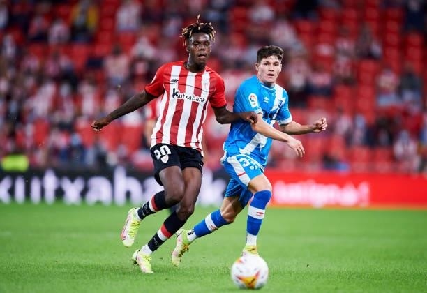 Nico Williams Jr of Athletic Club duels for the ball with Fran Garcia of Rayo Vallecano during the La Liga Santander match between Athletic Club and...
