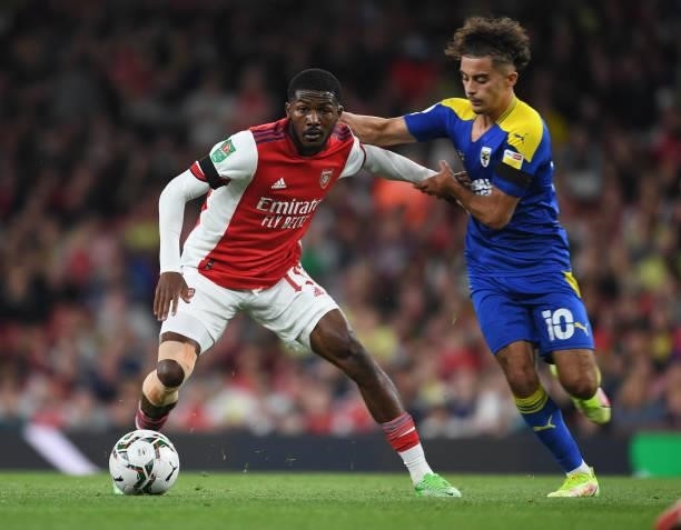 Ainsley Maitland-Niles of Arsenal holds off Ayoub Assal of Wimbledon during the Carabao Cup Third Round match between Arsenal and AFC Wimbledon at...