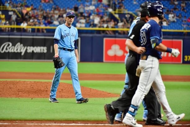 Ryan Borucki of the Toronto Blue Jays walks towards Kevin Kiermaier of the Tampa Bay Rays after hitting him with a pitch in the eighth inning at...