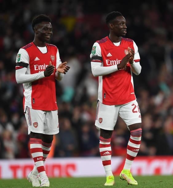 Bukayo Saka and Flo Balogun applaud the Arsenal fans after the Carabao Cup Third Round match between Arsenal and AFC Wimbledon at Emirates Stadium on...