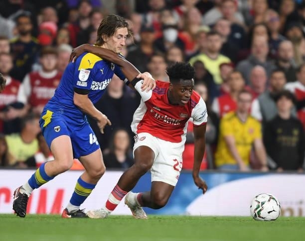 Sambi of Arsenal breaks past Alex Woodyard of Wimbledon during the Carabao Cup Third Round match between Arsenal and AFC Wimbledon at Emirates...