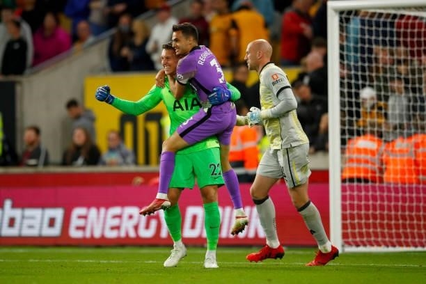 Pierluii Gollini and Sergio Reguilon of Tottenham Hotspur celebrate following their success in the penalty shoot-out during the Carabao Cup Third...