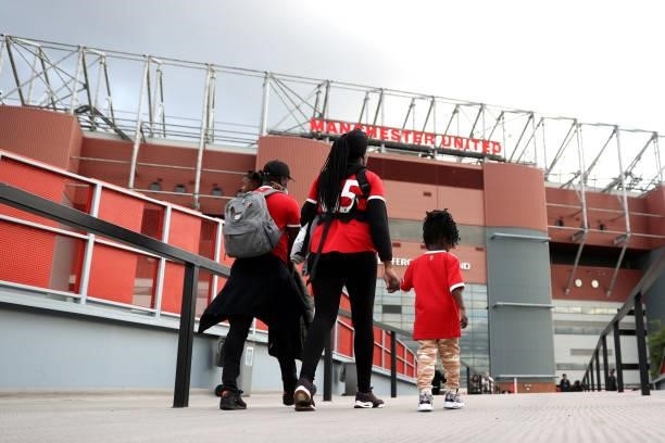 Fans make their way to the stadium prior to the Carabao Cup Third Round match between Manchester United and West Ham United at Old Trafford on...