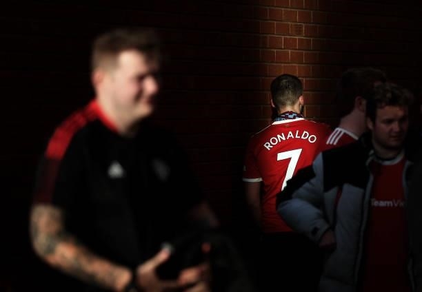 Fan wearing the shirt of Cristiano Ronaldo makes their way to the stadium prior to the Carabao Cup Third Round match between Manchester United and...