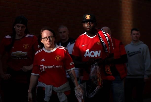 Fans make their way to the stadium prior to the Carabao Cup Third Round match between Manchester United and West Ham United at Old Trafford on...