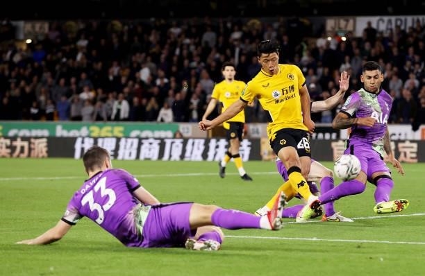 Hee-chan Hwang of Wolverhampton Wanderers shoots under pressure from Cristian Romero and Oliver Skipp of Tottenham Hotspur during the Carabao Cup...