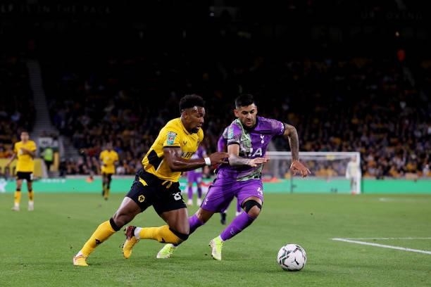 Adama Traore of Wolverhampton Wanderers is challenged by Cristian Romero of Tottenham Hotspur during the Carabao Cup Third Round match between...