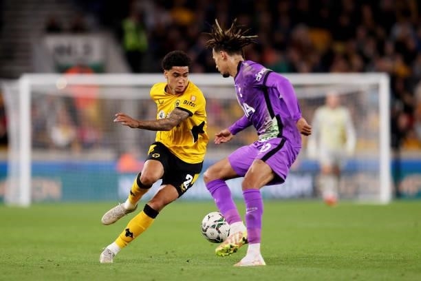 Ki-Jana Hoever of Wolverhampton Wanderers runs with the ball under pressure from Dele Alli of Tottenham Hotspur during the Carabao Cup Third Round...