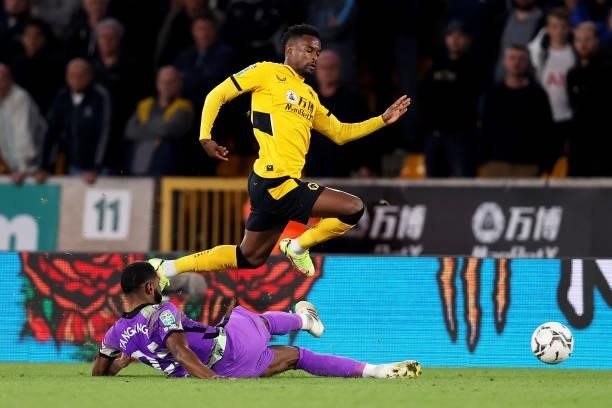 Nelson Semedo of Wolverhampton Wanderers is challenged by Japhet Tanganga of Tottenham Hotspur during the Carabao Cup Third Round match between...