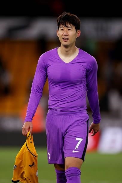 Son Heung-Min of Tottenham Hotspur walks off the pitch holding the shirt of Hee-chan Hwang during the Carabao Cup Third Round match between...